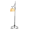 A dragon arm wrought iron floor lamp in the style of Samuel Yellin