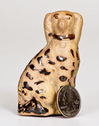 Rare Miniature Tanware Figure of a Spaniel, Greensboro or New Geneva, PA origin, circa 1885, slip-cast figure of a seated spaniel with incised locket, the surface decorated with Albany slip stripes and spots