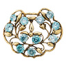 SEAMAN SCHEPPS BLUE ZIRCON & YELLOW GOLD BROOCH, scalloped openwork garland motif design with round faceted blue zircons