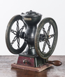 A Landers, Frary & Clark 2 wheel cast iron coffee mill or grinder