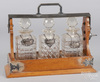 An English oak tantalus with 3 decanters