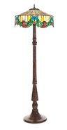 FLOOR LAMP WITH SLAG GLASS SHADE. American, 20th century. Bronze column and base, and nicely leaded shade with floral and bow decoration